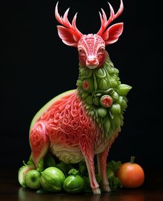 a sculpture of a deer made out of watermelon and cucumbers on a table