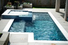 an outdoor hot tub in the middle of a backyard with water coming out of it