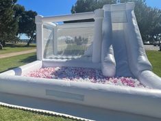 an inflatable water slide with pink and white flowers on the bottom is shown