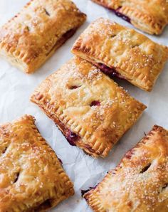 small pastries are lined up on wax paper