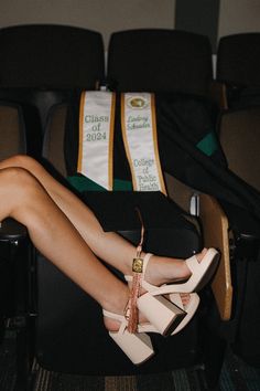 a woman in high heels sitting on a chair