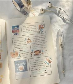 an open book with stickers on it next to headphones and earbuds