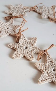 crocheted star ornaments with twine on white surface