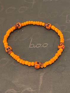 This is a skull beaded bracelet.  It would make a great addition to your Halloween costume. It would make a spooky gift for a teen for Halloween. It has five orange skull beads. It has orange seed beads. It was made with .8mm sturdy stretch string. I tie it several times to prevent breakage. It fits most teens and women. It stretches to fit on the wrist. All items are ready to be shipped I do combined shipping. Items ship in 2-5 business days. Check out more items at: http://www.etsy.com/shop/Me Halloween Novelty Beaded Bracelets With Round Beads, Halloween Bracelets With Letter Beads And Round Shape, Halloween Letter Beads Bracelet With Round Beads, Halloween Novelty Bracelet With Round Beads, Novelty Beaded Bracelets For Halloween, Adjustable Beaded Stretch Bracelet For Halloween, Orange Beaded Bracelets For Halloween, Handmade Halloween Festival Bracelets, Handmade Halloween Festival Bracelet