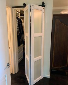 an open closet door in the middle of a room