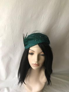 This is a classy vintage inspired 1950s - 1960s Dark emerald green half hat with a modern touch perfect summer fascinator as a bridal fascinator hat, mother of the bride hat, wedding hat, tea party hat, church hat or special occasion hat. This is a dark emerald or teal green headpiece create by hand and has a wire base that can fit any head size comfortably. WHAT MAKES THIS SO UNIQUE I form each piece while on my head to see how it fits and looks and then take it off and hand pleat and sew each Bride Fascinator, Dark Green Wedding, Special Occasion Hats, Mother Of The Bride Hats, Bridal Fascinator, Church Hat, Bride Hat, Tea Party Hats, Wedding Hat