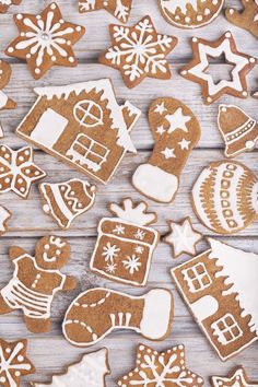 gingerbread cookies decorated with icing and snowflakes on a wooden table top