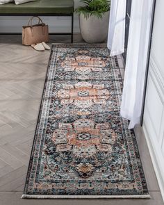 a large area rug with an ornate design on the floor in front of a door