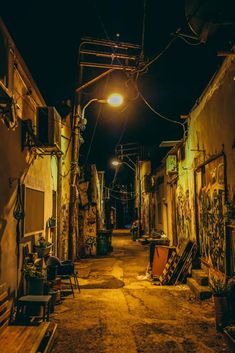 an alley at night with graffiti all over the walls