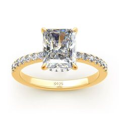 a yellow gold engagement ring with a princess cut diamond and side stones on the band