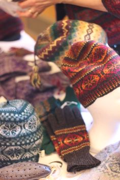 hats and mittens are on display for sale