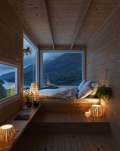 a bedroom with wooden walls and flooring is lit up at night