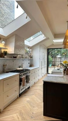 an open kitchen with skylights and white cabinets