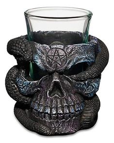 a glass with a skull on it and a pentagramus in the middle is shown