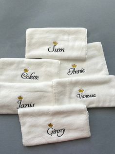 four white towels with embroidered name and crown on them