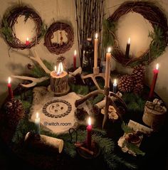 a table topped with lots of candles and wreaths