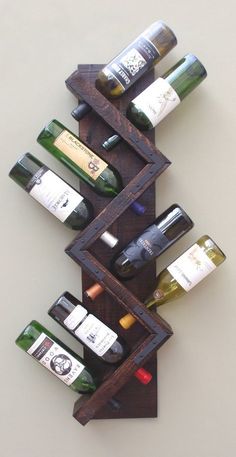 a wooden wine rack with several bottles in it