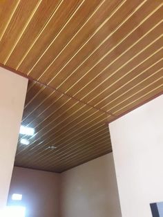 the ceiling is covered with wood planks