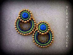 two pairs of beaded earrings sitting on top of a table