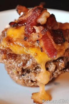 a close up of a plate of food with meat and cheese on it's side