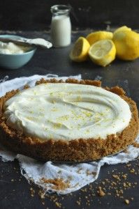 there is a pie on the table with lemons and other food items around it