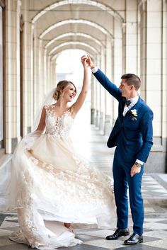 a bride and groom dancing together in an archway