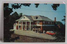 an old postcard with people standing in front of a train station