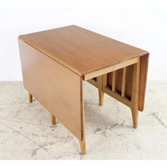 a small wooden table with two drawers on one side and an open drawer on the other