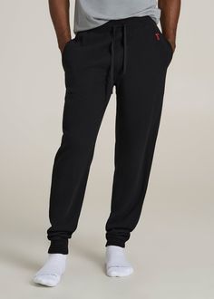 Upgrade Your Loungewear Game Tall Men's Jogger Pants That Fit Just Right Take your loungewear to the next level with our Waffle-Knit Lounge Jogger for tall men. These extra-long men's joggers offer a regular fit with a mid-rise that sits comfortably, and the drawstring waist ensures a secure fit. Side seam pockets add practicality to this essential home wear piece. Perfect for relaxing at home or running errands, these tall joggers combine comfort and functionality tailored for your taller frame Casual Black Sweatpants For Relaxation, Black Casual Sweatpants, Black Cotton Comfort Stretch Sweatpants, Black Relaxed Fit Casual Pants, Black Relaxed Fit Pants For Relaxation, Black Stretch Joggers For Lounging, Black Comfort Stretch Full Length Sweatpants, Black Relaxed Fit Sweatpants For Relaxation, Black Sweatpants With Ribbed Waistband For Lounging