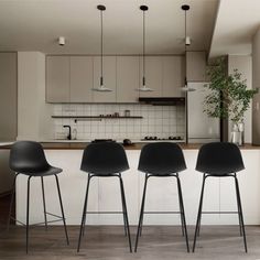 three black chairs sitting in front of a kitchen counter