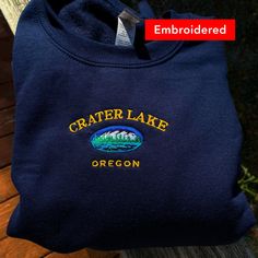 *SIZES ARE UNISEX* -I'd suggest your usual size for a more fitted look, or sizing up for a more relaxed fit. *these sweatshirts are extra comfy when oversized 🏔 "Crater Lake Oregon" embroidered on a comfy cute vintage-style crewneck. A sturdy and warm sweatshirt bound to keep you warm in the colder months. A pre-shrunk, classic fit sweater that's made with air-jet spun yarn for a soft feel and reduced pilling. Your new favorite sweatshirt! * 50% cotton, 50% polyester * Pre-shrunk * Classic fit Casual Crew Neck Sweats With Embroidered Logo, Casual Sweats With Embroidered Logo And Crew Neck, Relaxed Fit Crew Sweater With Embroidered Logo, Custom Embroidery Relaxed Fit Crew Neck Sweatshirt, Custom Embroidered Crew Neck Sweatshirt In Relaxed Fit, Relaxed Fit Sweatshirt With Custom Embroidery And Crew Neck, Relaxed Fit Crew Neck Sweatshirt With Custom Embroidery, Casual Winter T-shirt With Embroidered Logo, Casual T-shirt With Embroidered Logo For Winter