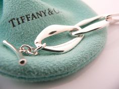 Have you been searching for a piece of Tiffany jewelry that made the brand an icon? You just stumbled upon one of them! Offered for sale is a gorgeous Tiffany & Co. Silver Peretti Aegean bracelet. If you must have just one Tiffany piece ... this should be at the top of your preference list! :) Very substantial and unique Tiffany piece that you will get your money's value for. It is a wonderful bracelet that looks very contemporary, elegant and super chic. The piece looks great worn alone, but wo Box Pouch, Tiffany Jewelry, Bracelet Bangle, Tiffany Heart, Heart Charm Bracelet, Tiffany & Co., Link Chain, You Must, Bangle Bracelets