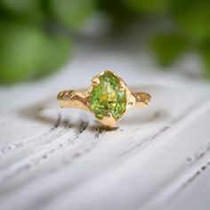 ✨ Current processing time is 4 weeks ✨     Bold but delicate, our stunning Peridot ring is uniquely handcrafted by wax and cast in Solid 14k Gold - the organic textured band adds a touch of rustic charm to this ethereal beauty.  As the birthstone for August, this green crystal ring takes centre stage by creating a mesmerizing play of light. This one of a kind engagement ring will be sure to complete your unique love story T H E ∙ S M A L L ∙  D E T A I L S * Rose cut Peridot (8 x 11mm) * Solid 1 Handmade Peridot Rings As Gift, Green Peridot Crystal Ring For Weddings, Elegant Green Peridot Crystal Ring, Green Peridot Crystal Ring, Nature-inspired Peridot Rings As Gift, Green Crystal Ring, Gold Peridot Ring, Nature Inspired Engagement Ring, December 1st