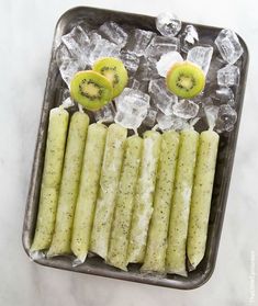 sliced kiwis and ice on a tray with slices of kiwi in the middle