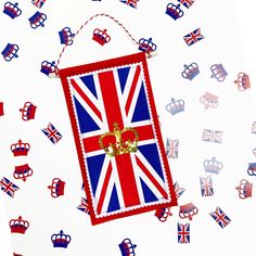 the british flag has been decorated with gold letters and crown jewels on it, as well as red white and blue confetti