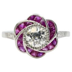 a white gold ring with pink stones in the center