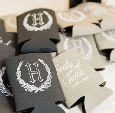 black and white wedding favors with monogrammed names on them are laid out in rows