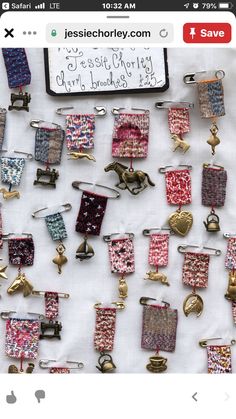 a bunch of different colored clips on a white tablecloth with a sign in the background