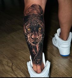 a man's leg with a tiger tattoo on it