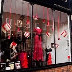 a store front window with red and white decorations