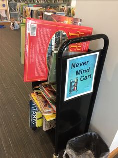 there is a sign that says never mind card next to some books on the shelf