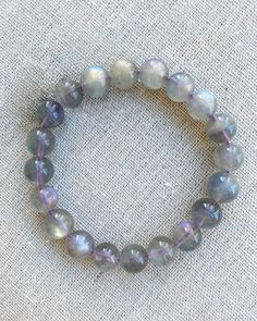 Discover the mystical allure and transformative energy of our 10mm Round Beaded Stretch Stacking Labradorite Purple Chatoyant Crystal Bracelet This exquisite handmade item features stunning labradorite beads with captivating purple chatoyancy, known for their mesmerising play of colours and powerful healing properties.  Labradorite Healing Properties: -Enhances intuition and psychic abilities: Boosts intuitive abilities and heightens awareness. -Protects against negative energies: Shields the aura and prevents energy leaks. -Promotes transformation and strength: Supports personal growth and strengthens willpower. -Reduces stress and anxiety: Calms an overactive mind and balances emotions. -Stimulates imagination and creativity: Encourages innovative thinking and artistic expression. The br Spiritual Labradorite Beaded Bracelets As Gift, Healing Labradorite Beaded Bracelets With 8mm Beads, Labrodite Crystal Bracelet, Spiritual Labradorite Beaded Bracelets, Adjustable Labradorite Spiritual Beaded Bracelets, Energy Leaks, Labradorite Healing Properties, Innovative Thinking, Grey Moonstone