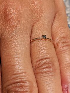 a close up of a person's hand with a diamond ring on top of it