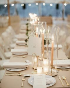 the table is set with candles and place settings