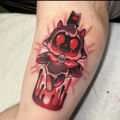 a tattoo on the leg of a man with a red and black ink splattered design