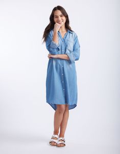 DESCRIPTION Introducing the Cleo Vintage Denim dress by White & Co. This must-have Spring wardrobe essential brings effortless style with its laid-back, vintage look. Crafted from soft, lightweight, breathable tencel denim, this shirt dress features a button-down front, twin chest pockets, and a flattering curved hem. Perfect for those days when you want to look chic without trying too hard. Pair the Cleo Vintage Dress with white sneakers for a casual day out, or dress it up with strappy sandals Dress With White Sneakers, Vintage Denim Dress, Spring Wardrobe Essentials, Trying Too Hard, Tencel Denim, Denim Shirt Dress, Spring Wardrobe, Vintage Dress, Look Chic