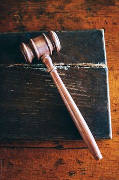 a wooden judge's gaven on top of a wooden table