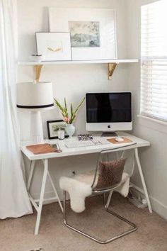 a white desk with a computer on top of it