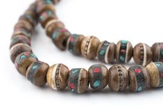 "Admire this special strand of handmade mala beads made from horn. Each little bead has been inlaid with brass, turquoise or color bits. The strand is approximately 28 long, and beads measure approximately 6-7 x 8mm. Beautiful brown color. Another great strand of beads to add to your collection! Bead Size: 6-7 x 8mm Strand Length: 28\" Approximate # of Beads: 108 Hole Size: 2mm Bone Species: Bubalus bubalis (Water Buffalo)  MORE BONE BEADS AVAILABLE  Browse our Etsy store for thousands of other Wooden Round Beads For Jewelry Making, Round Wooden Beads For Jewelry Making, 8mm Rondelle Beads For Jewelry Making, Brown 8mm Round Beads, Brown 8mm Beads, Brown Beaded Necklaces With 8mm Round Beads, Brown Beaded Necklaces With 8mm Beads, Brown Beaded Necklace With 8mm Round Beads, Beads Mala