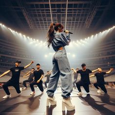 a woman standing on top of a stage in front of other people holding baseball bats